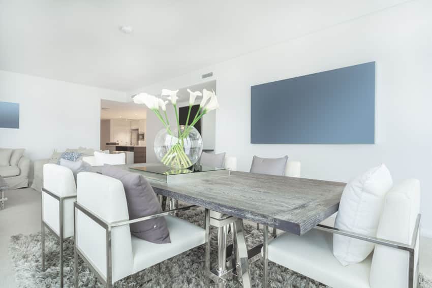 Dining room with reclaimed wood table and silver chairs 