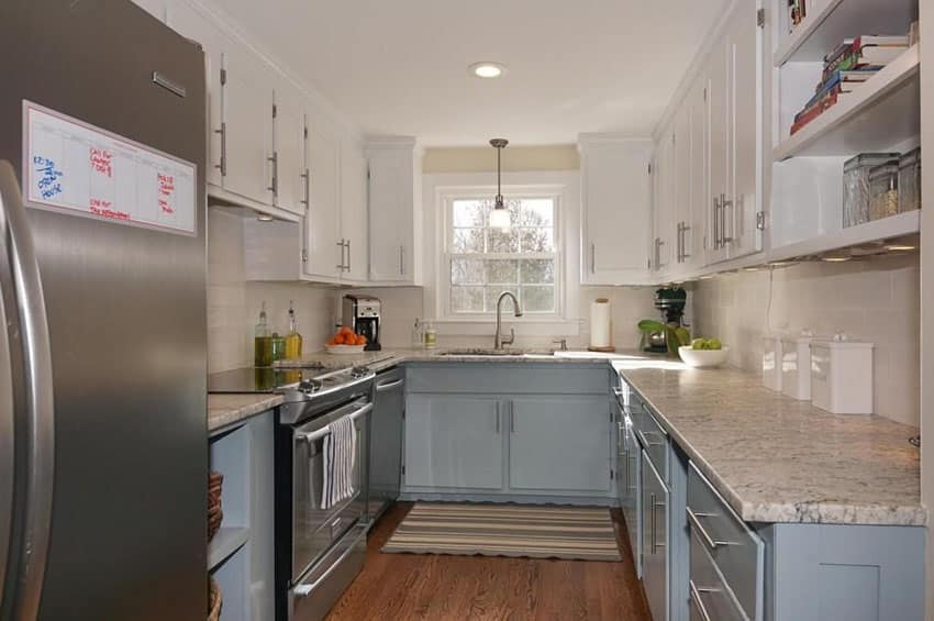 Cottage style kitchen with blue under sink cabinets, open shelving and white cabinetry