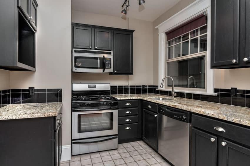 Kitchen with small floor tiles, window with white frame and open cabinetry