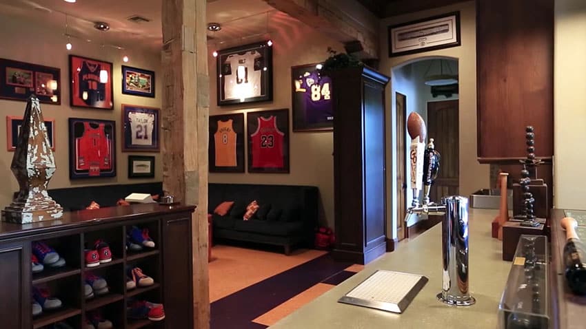 Sports man cave with team jerseys and beer tap
