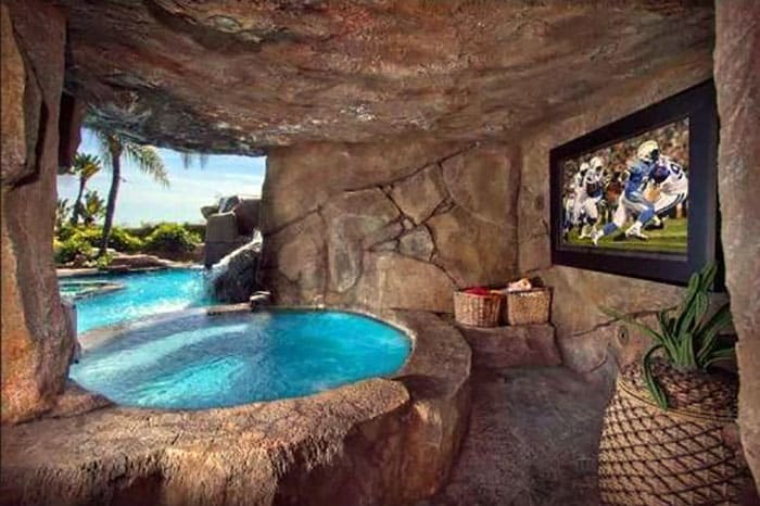 Stone hot tub man cave with tv