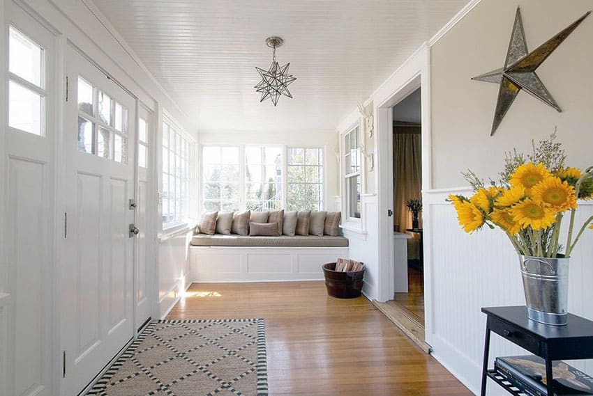 Sunroom window seat bench in room with wainscoting
