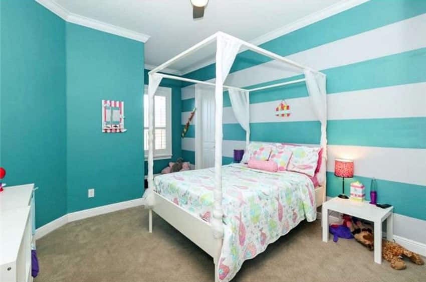 Teal and white striped wall bedroom design with four post bed