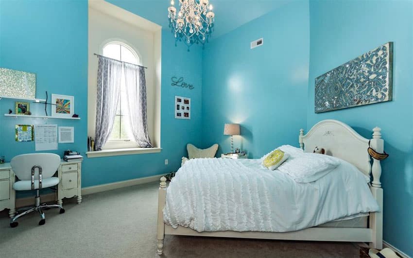 Teal painted room with high ceiling and chandelier