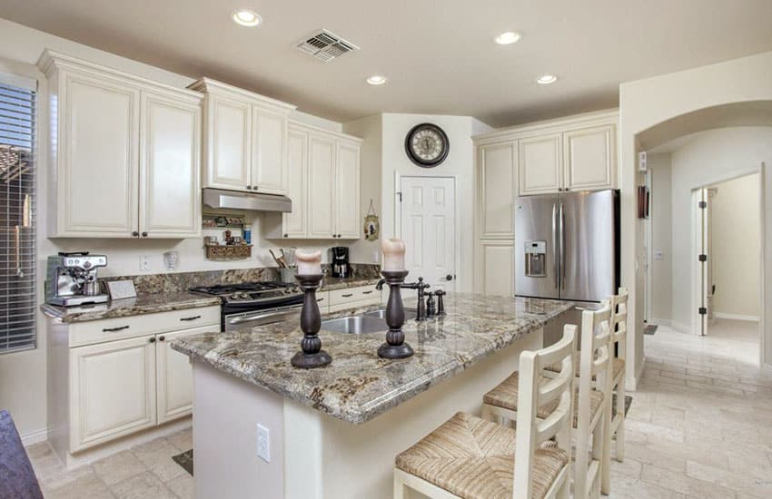 Traditional kitchen with antique white cabinets and breakfast bar island