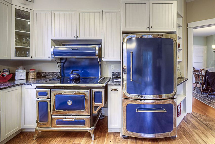 Kitchen appliances with antique blue finish and cabinets with beadboard panels