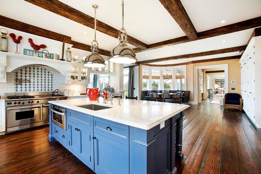 Open layout kitchen with exposed beam ceiling and red rooster design accent