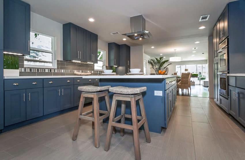 Transitional kitchen with dark blue cabinets, white quartz counters and porcelain tile flooring