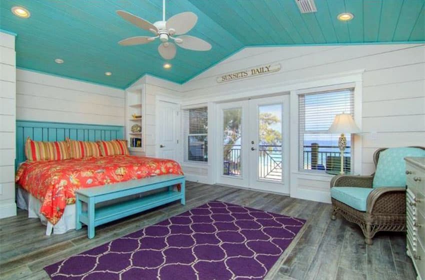 Tropical beach bedroom with purple rug, teal color ceiling and teal bed frame