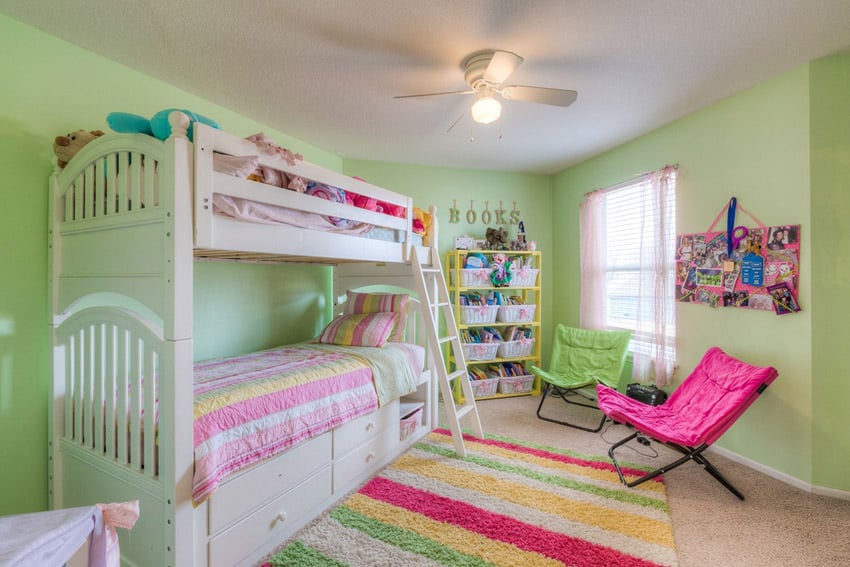 White bunk bed in girls bedroom with built-in storage drawers