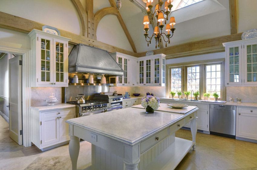 White cabinet cottage kitchen with marble counter island and high ceiling