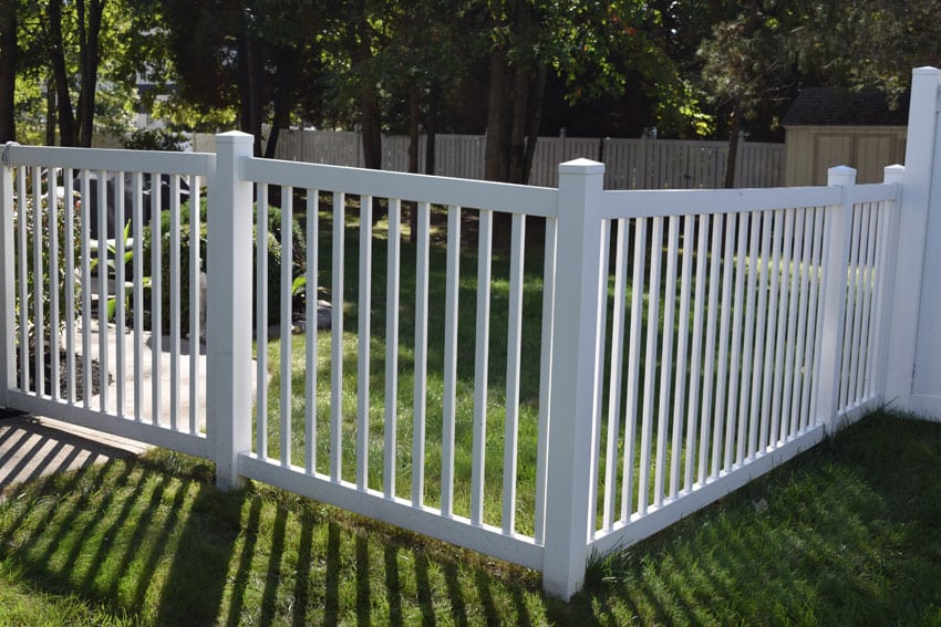 White vinyl fence in backyard