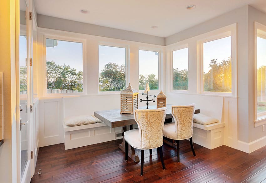 Window seat in dining room with white cushions