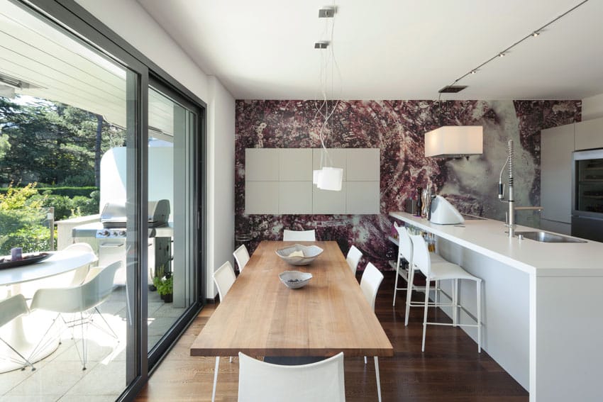 Room with violet graphic wall, picture windows and white mesh chairs