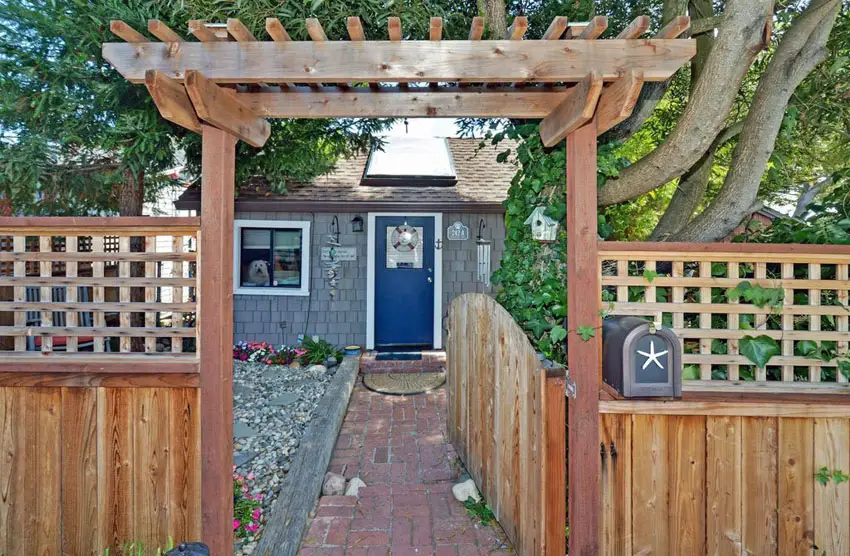 Arbor in front of the house, brick pathway and steel mailbox