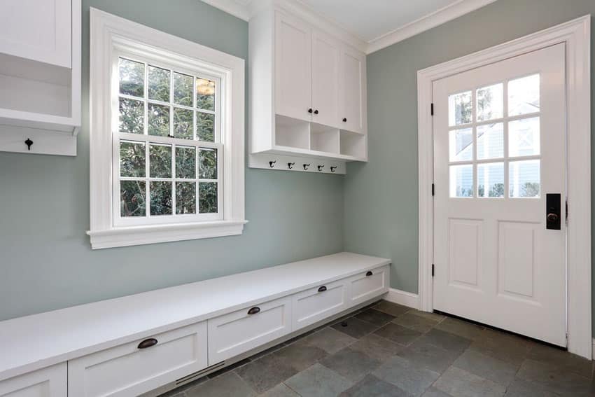 Beautiful white and gray mudroom with cabinet storage and bench