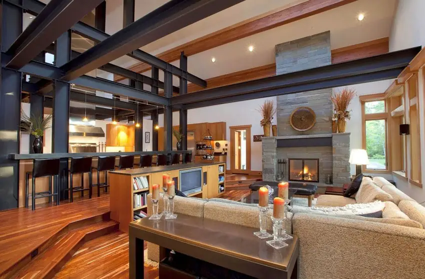 Modern rustic sunken living room with bright wood floors and slate fireplace