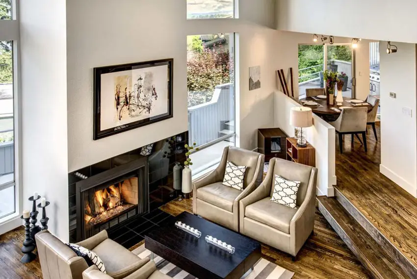 Sunken space with fireplace, leather chairs and carpet
