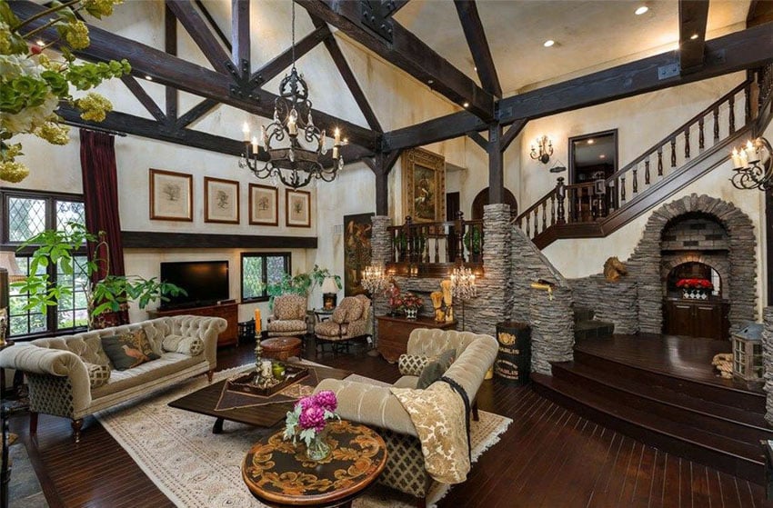 Craftsman living room with dark wood flooring, stone arches and trim