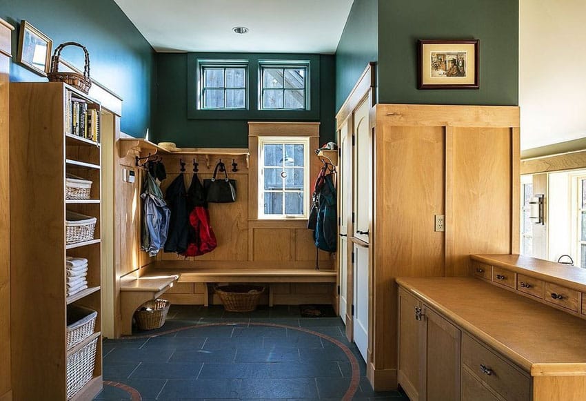 Craftsman mud room with storage cabinets, wood bench and closet