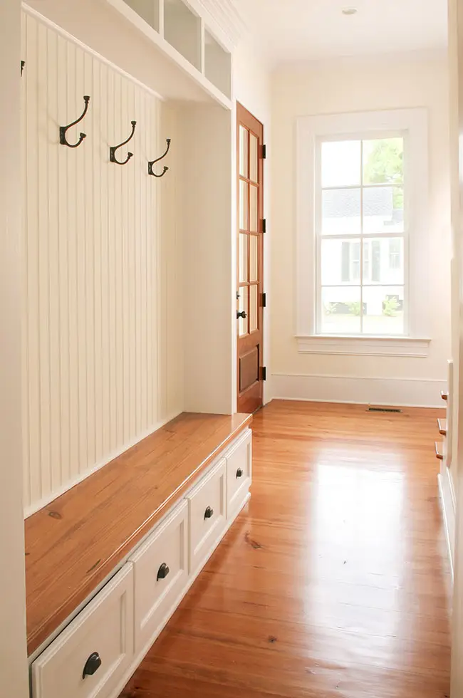 Entryway with mullioned window and white oak doors