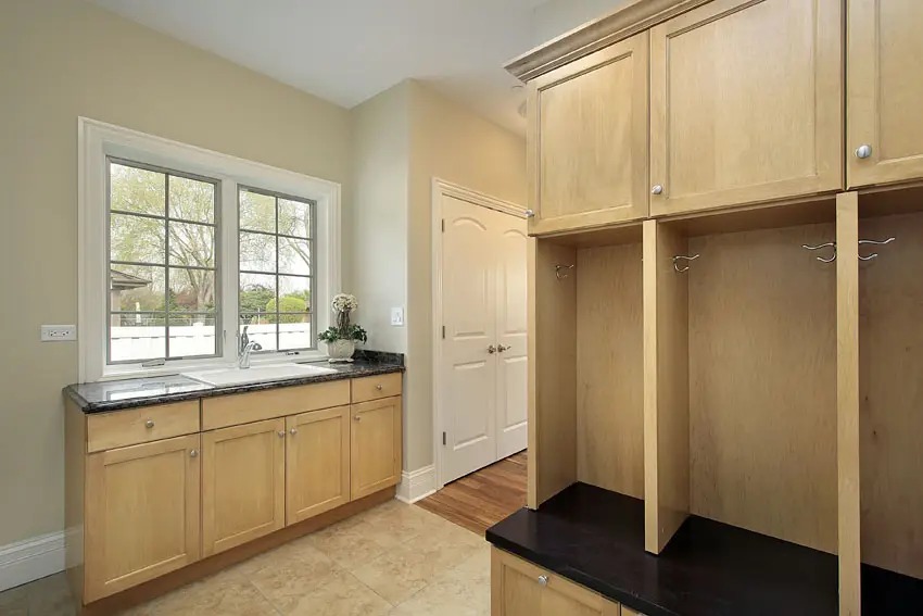 Cream colored tiles with black countertop with sink