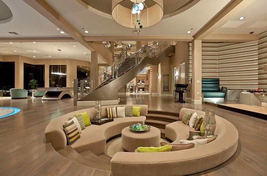 Sunken living room with wood flooring and high ceilings