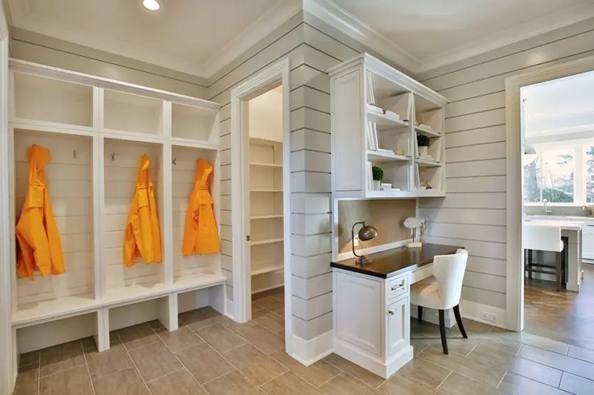 Mudroom with coat racks and access to pantry