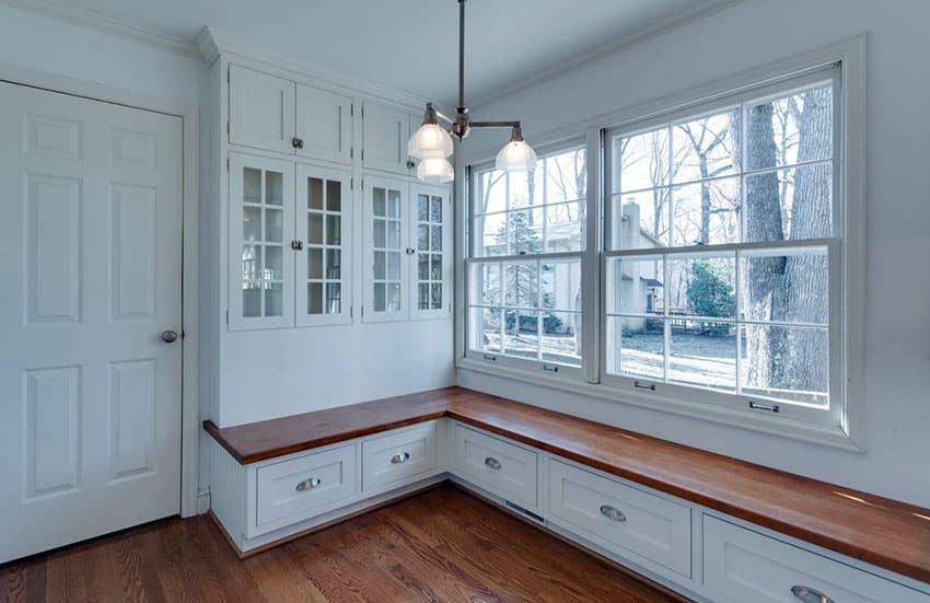 Mudroom with window seat bench and storage cabinets