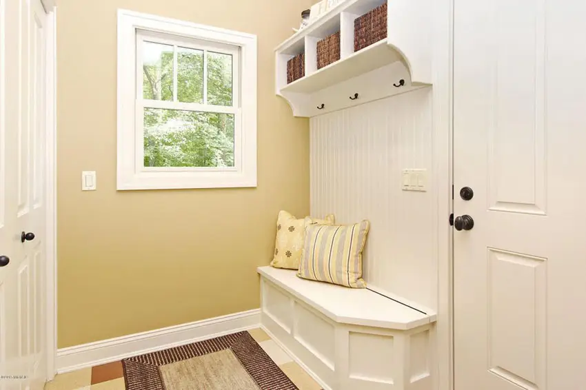 Small corner mudroom with wall hooks and double door cabinet
