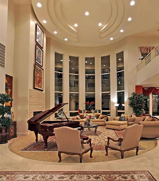 Traditional style round sunken living room with grand piano
