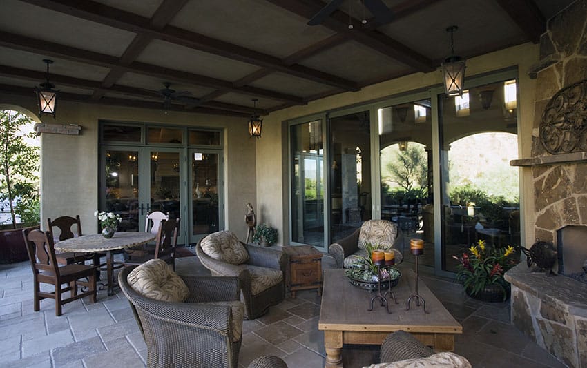 Beautiful covered patio with stone fireplace and furniture