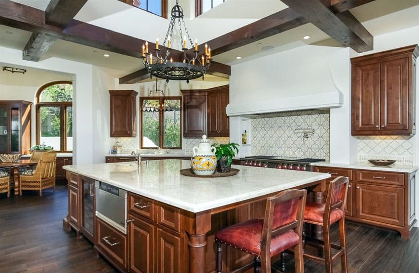 Beautiful Tuscan style kitchen with white marble counter and dark wood floors