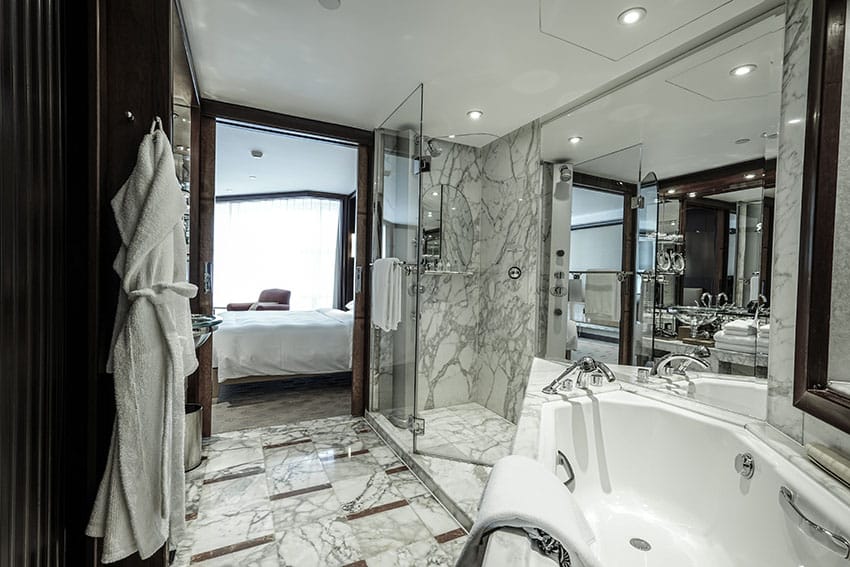 Compact bathroom with marble floors and shower