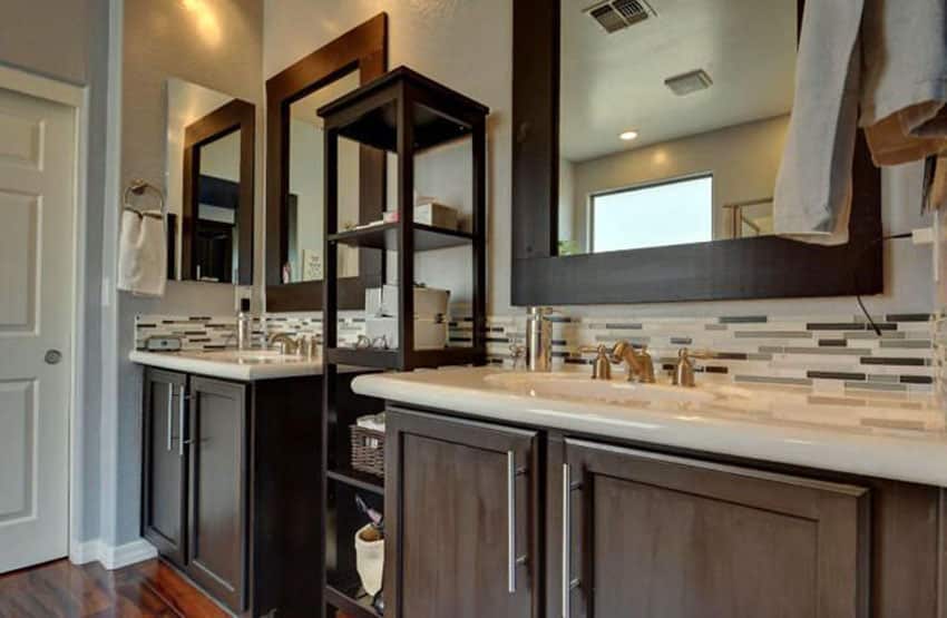 Contemporary bathroom with center shelving unit between sinks