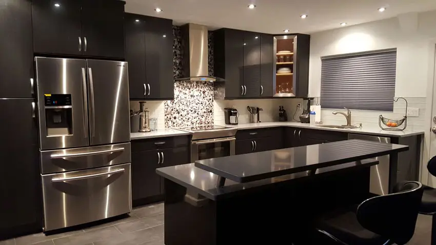 Contemporary black cabinet kitchen with breakfast bar island