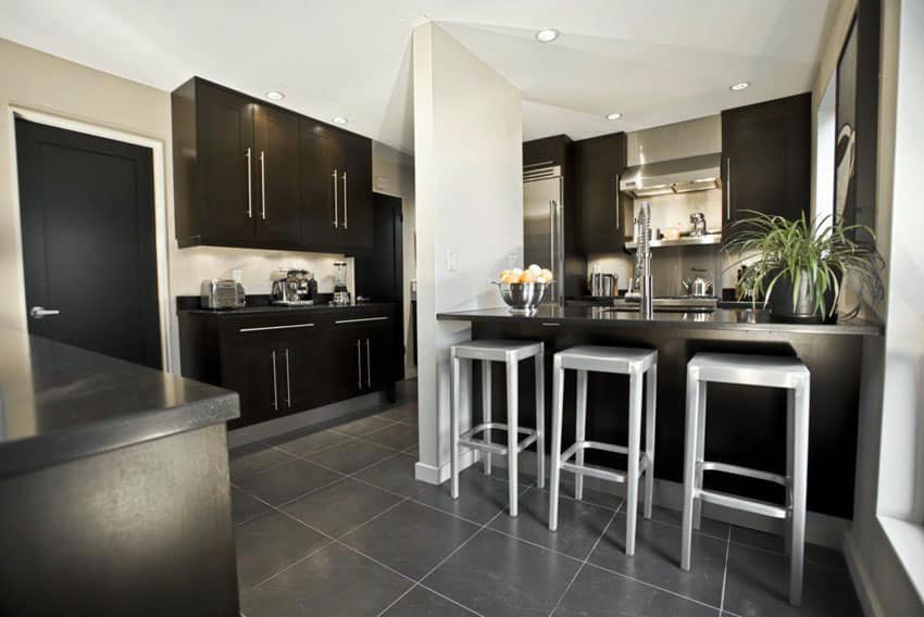 kitchen with black cabinetry and gray porcelain flooring tiles