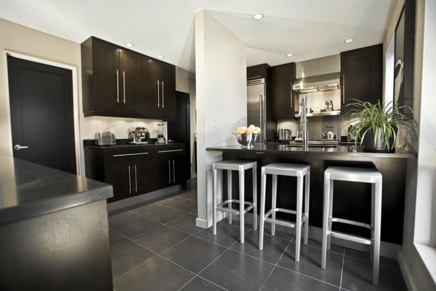 kitchen with raven black peninsula and cabinetry and gray porcelain tiles on floor