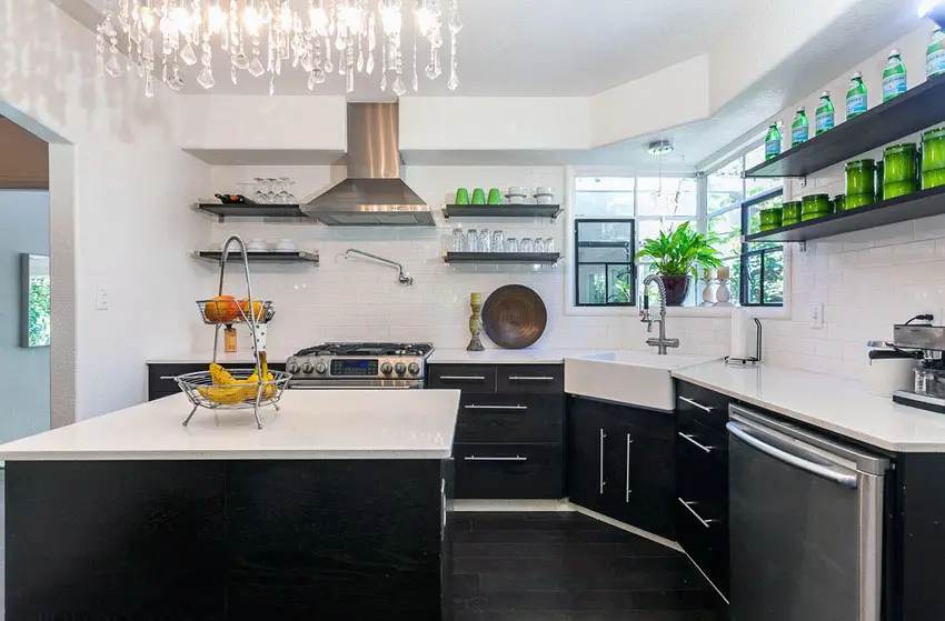 Contemporary kitchen with black cabinets and crystal chandelier