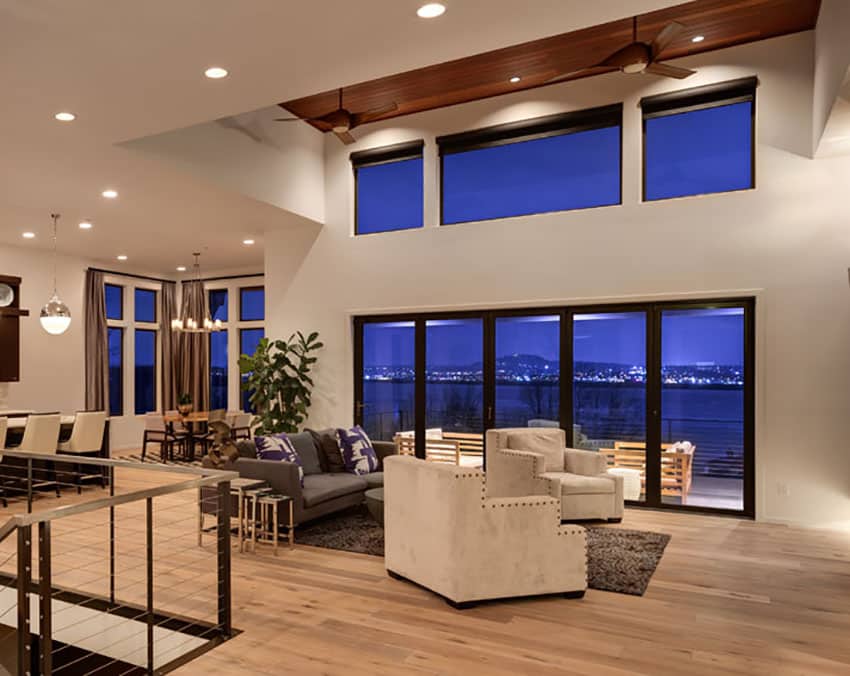Contemporary living room with high ceiling and wood flooring
