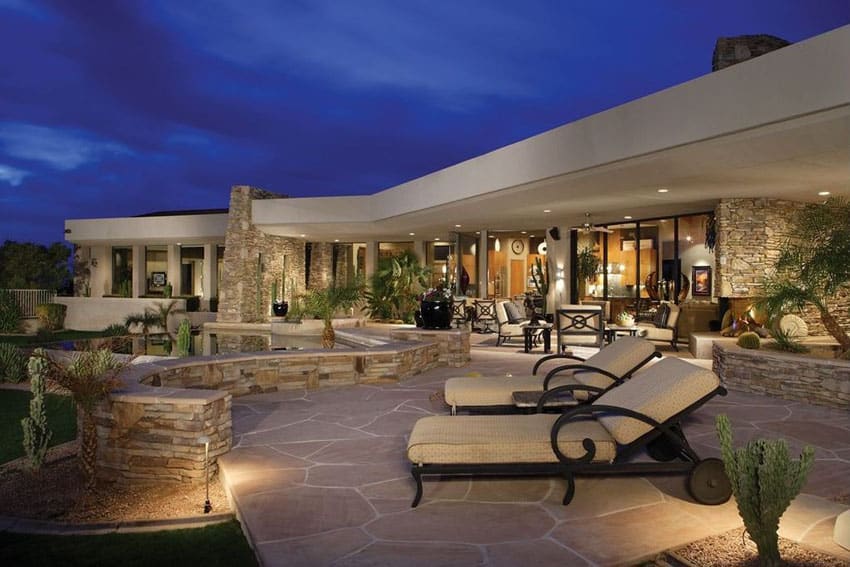 Contemporary flagstone patio design with stacked stone benches 