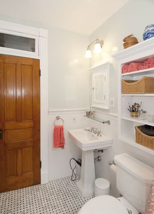 Cozy bathroom with white wall cabinet glass shelf and pedestal sink