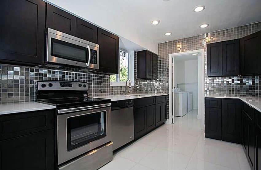 Dark cabinet kitchen with metallic backsplash