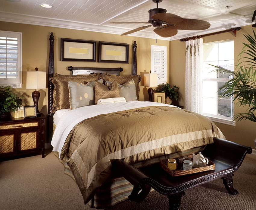 Bedroom with white plantation windows, furniture with dark finish and peanut shade duvet