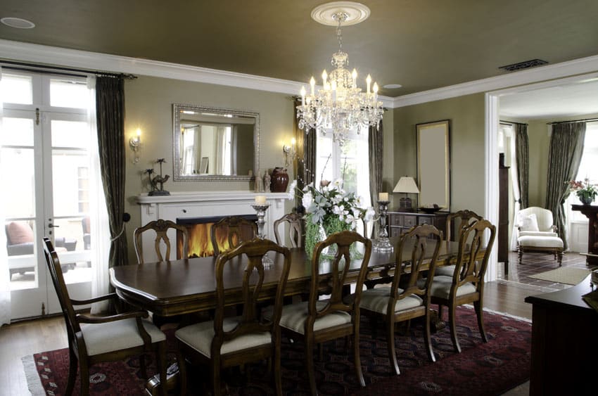 Elegant formal dining room with long wood table and fireplace
