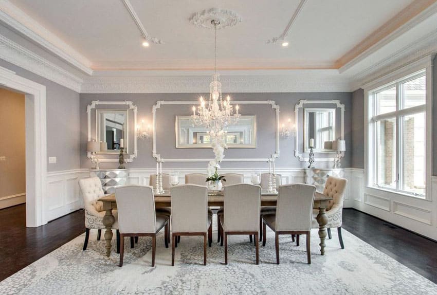 Elegant gray formal dining room with wainscoting and crystal chandelier