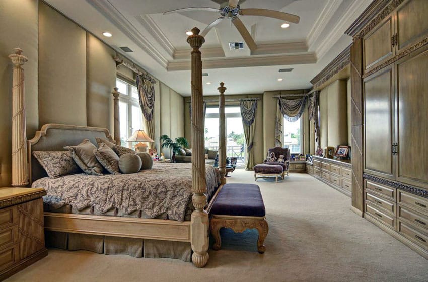 Elegant tan bedroom with wood built in storage and four poster bed