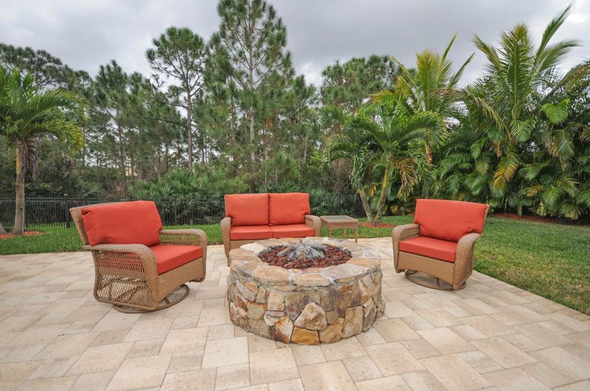 Flagstone patio with round rubble stone fire pit