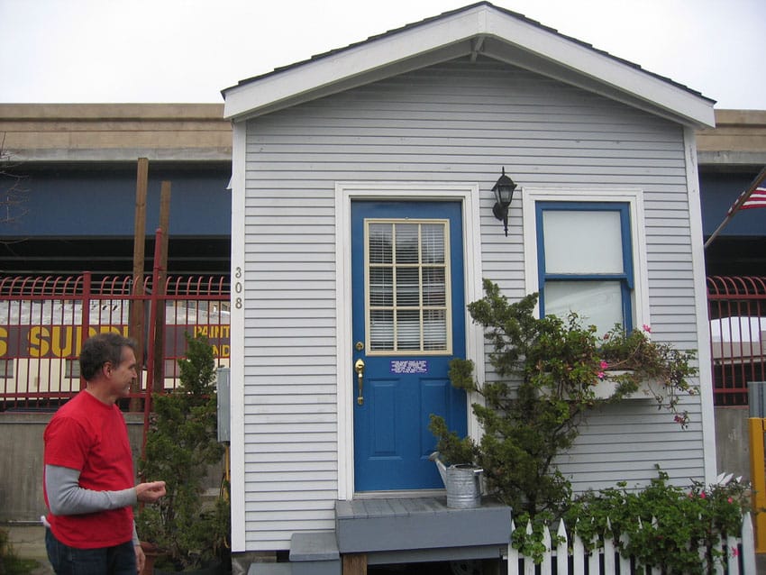 Gray tiny house with blue door