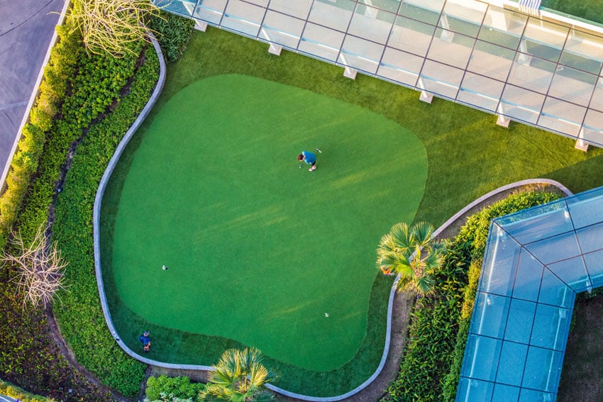Golfer teeing up to play shown from above